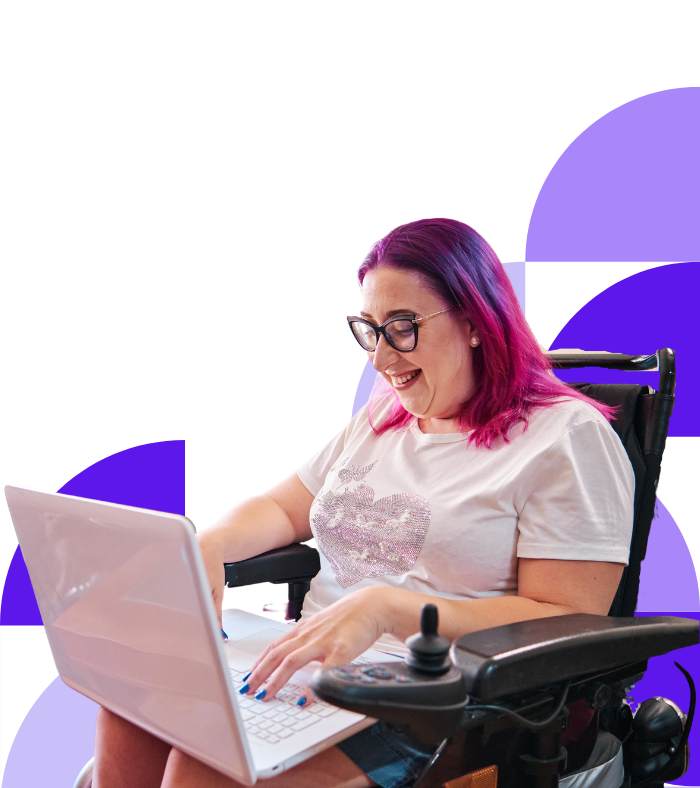 Smiling woman in a wheelchair working from her laptop